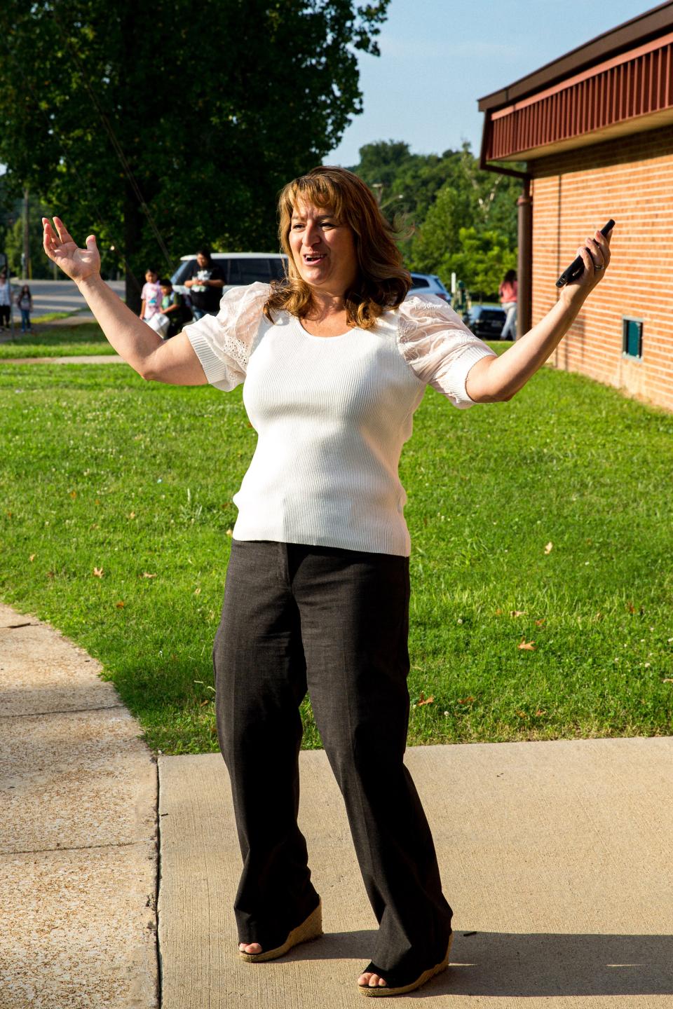 Maury County Schools Superintendent Lisa Ventura cheers with joy as children and their parents walk into Riverside Elementary School on the first day of school in Columbia, Tenn. on Monday, Aug. 7, 2023.