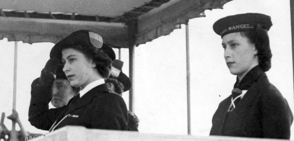 <p>Princess Elizabeth in her uniform of Sea Ranger, and Princess Margaret (right), at a drumhead service and march past by Girl Guides in London’s Hyde Park (PA Archive) </p>