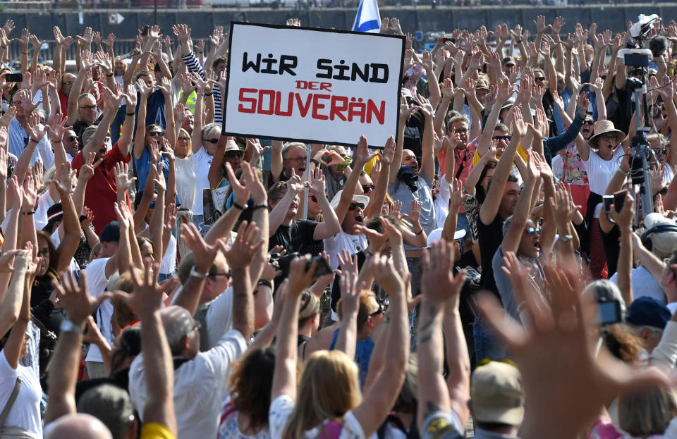 20 September 2020, North Rhine-Westphalia, Duesseldorf: Participants of a demonstration protest with signs on the Rhine meadows against the measures to combat the coronavirus. Photo: Roberto Pfeil/dpa (Photo by Roberto Pfeil/picture alliance via Getty Images)