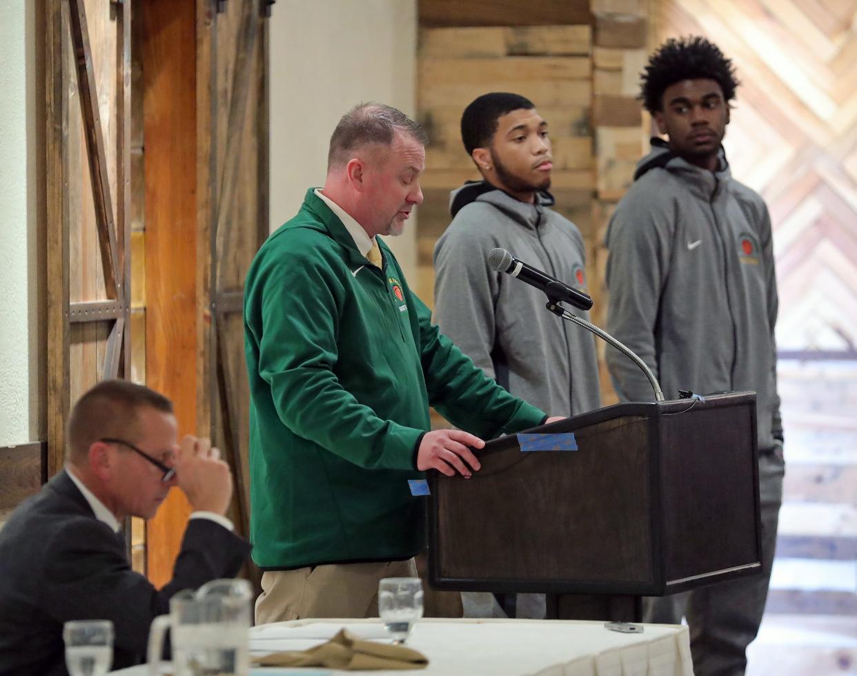 Firestone boys basketball coach Brian Neugebauer introduces Lamar Dampier and Johnathan White during the Akron City Series high school basketball media day at Guy's Party Center on Tuesday in Akron.