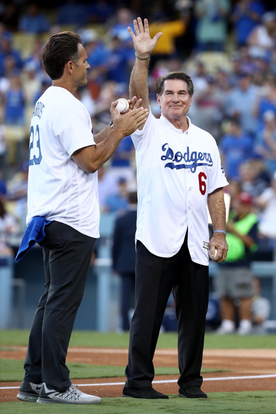 Former Los Angeles Dodgers Steve Garvey waves to the crowd as he stands alongside Eric Karros before the ceremonial first pitch before game five of the National League Division Series at Dodger Stadium on October 20, 2016 in Los Angeles, California.  (Photo by Sean M. Haffey/Getty Images)