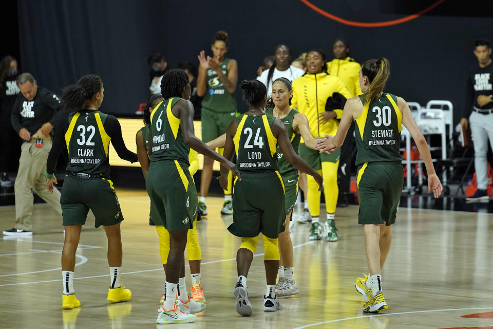 The Seattle Storm celebrate their win over the Minnesota Lynx during Game 2 of a WNBA basketball semifinal round playoff series Thursday, Sept. 24, 2020, in Bradenton, Fla. (AP Photo/Chris O'Meara)