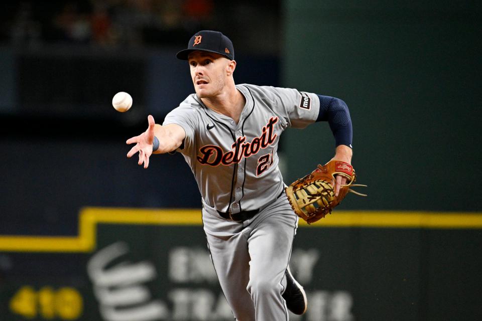 Tigers first baseman Mark Canha tosses the ball to first base for an out during the first inning against the Rangers on Monday, June 3, 2024, in Arlington, Texas.