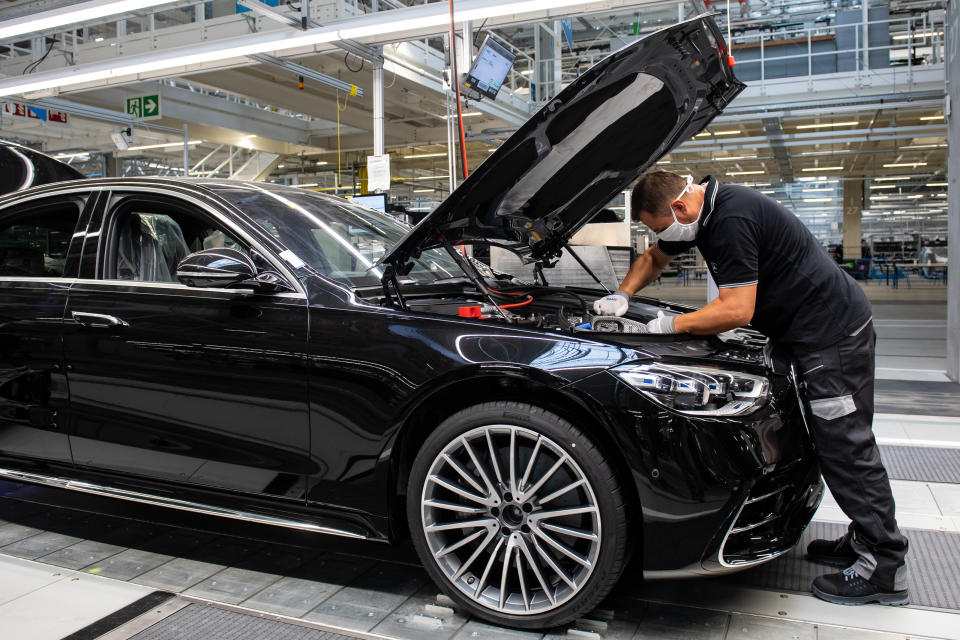 SINDELFINGEN, GERMANY - SEPTEMBER 02: A worker wearing a face mask assembles the new S-Class Mercedes-Benz passenger car at the new "Factory 56" assembly line at the Mercedes-Benz manufacturing plant on September 2, 2020 in Sindelfingen, Germany. The luxury car is the 11th generation S-Class and is scheduled to reach dealers in November. (Photo by Lennart Preiss/Getty Images)