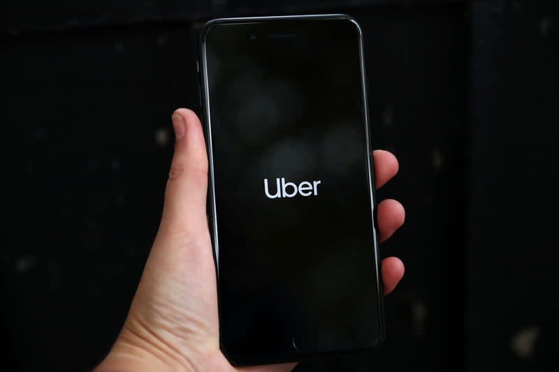 FILE PHOTO: Uber's logo is displayed on a mobile phone in London, Britain, September 14, 2018. REUTERS/Hannah Mckay