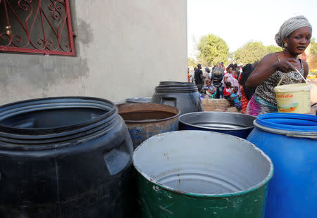 A Gambian refugee collects water at a camp at Senegal's border with Gambia in Karang, January 20, 2017. REUTERS/Thierry Gouegnon