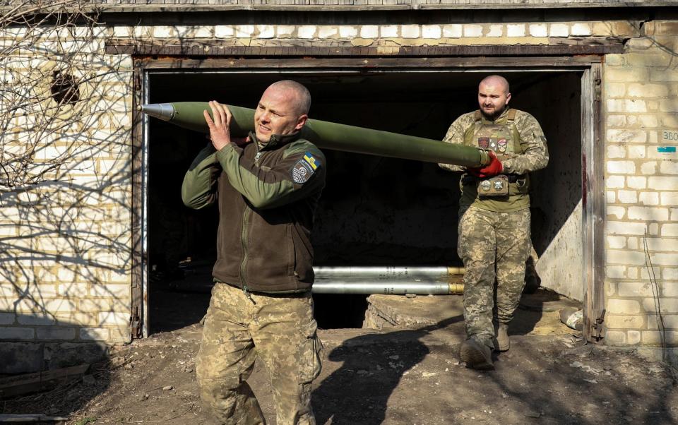 Ukrainian servicemen prepare to load a BM-21 Grad multiple launch rocket system (MLRS)