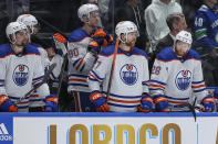 Edmonton Oilers' Cody Ceci, Corey Perry, Brett Kulak and Connor Brown, from left, stand on the bench during the final seconds in Game 5 of the team's NHL hockey Stanley Cup second-round playoff series against the Vancouver Canucks, Thursday, May 16, 2024, in Vancouver, British Columbia. (Darryl Dyck/The Canadian Press via AP)