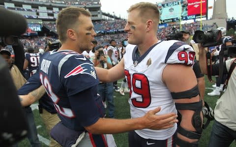New England Patriots quarterback Tom Brady, left, and Houston Texans defensive end J.J. Watt, right, speak at midfield - Credit: AP