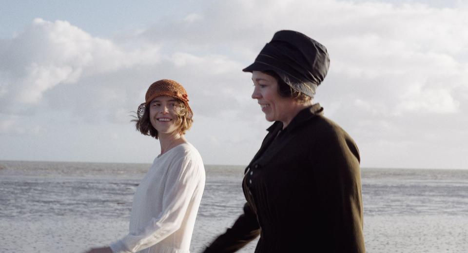 a man and woman standing on a beach