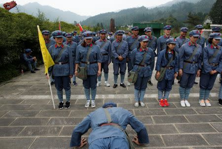 People dressed in replica red army uniforms take part in a Communist team-building course extolling the spirit of the Long March, organised by the Revolutionary Tradition College, in the mountains outside Jinggangshan, Jiangxi province, China, September 14, 2017. REUTERS/Thomas Peter