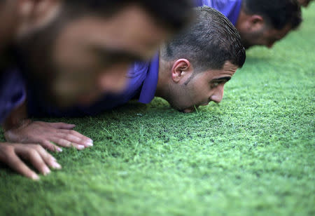 Palestinian applicants for a private security guard job at Castle Security company undergo a physical examination in an open-air playground in Gaza City November 21, 2016. REUTERS/Ibraheem Abu Mustafa