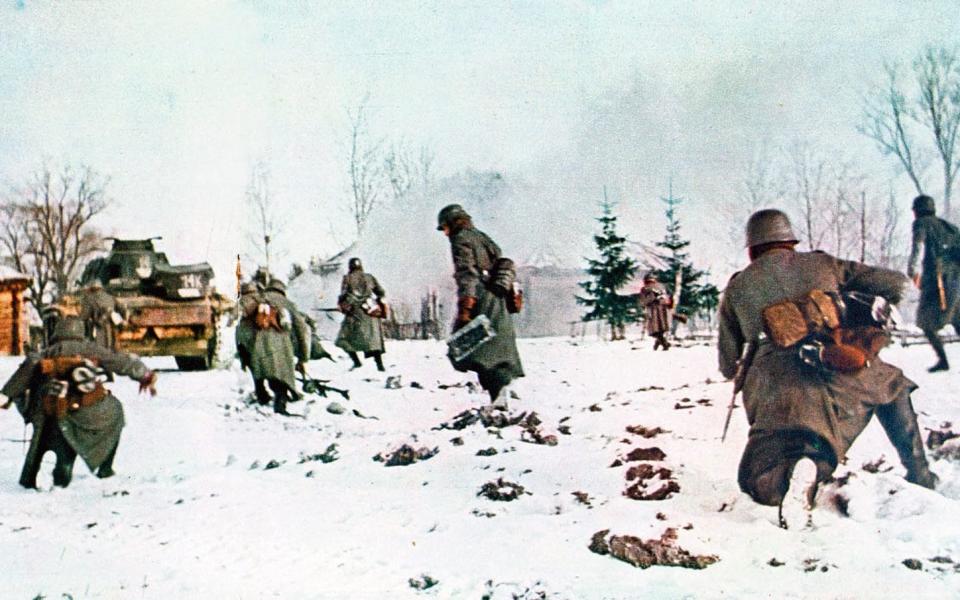 German infantrymen following a tank towards Moscow in the snow - Print Collector/Getty Images