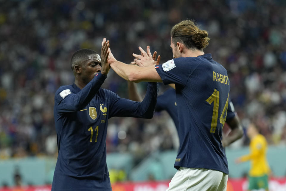 France's Adrien Rabiot, right, celebrates with his teammate Ousmane Dembele after scoring his side's opening goal during the World Cup group D soccer match between France and Australia, at the Al Janoub Stadium in Al Wakrah, Qatar, Tuesday, Nov. 22, 2022. (AP Photo/Francisco Seco)