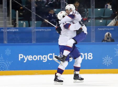 Ice Hockey - Pyeongchang 2018 Winter Olympics - Men's Playoff Match - Slovenia v Norway - Gangneung Hockey Centre, Gangneung, South Korea - February 20, 2018 - Alexander Bonsaksen of Norway celebrates with teammate Mats Rosseli Olsen after scoring a goal in overtime to defeat Slovenia. REUTERS/Kim Kyung-Hoon