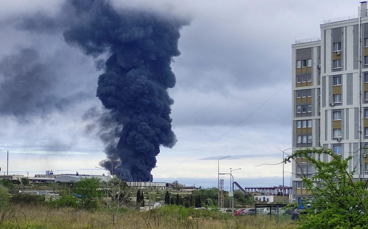 Smoke rises after a drone strike on a fuel tank in Sevastopol in April