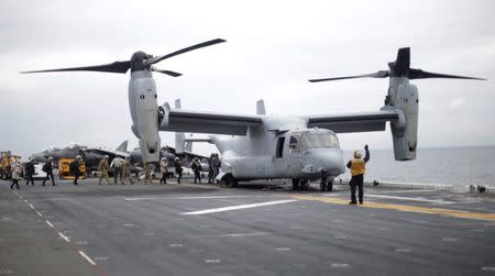 Participants in a ceremony marking the start of Talisman Saber 2017, a biennial joint military exercise between the United States and Australia, board a U.S. Marines MV-22B Osprey Aircraft on the deck of the USS Bonhomme Richard amphibious assault ship off the coast of Sydney, Australia, June 29, 2017. REUTERS/Jason Reed