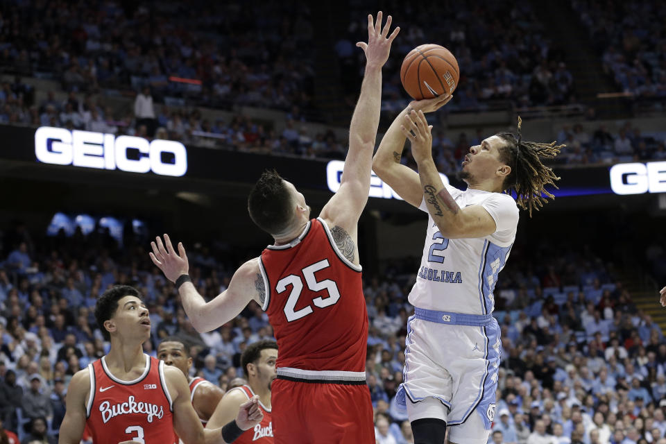 Ohio State guard D.J. Carton (3) and forward Kyle Young (25) defend while North Carolina guard Cole Anthony (2) shoots during the first half of an NCAA college basketball game in Chapel Hill, N.C., Wednesday, Dec. 4, 2019. (AP Photo/Gerry Broome)