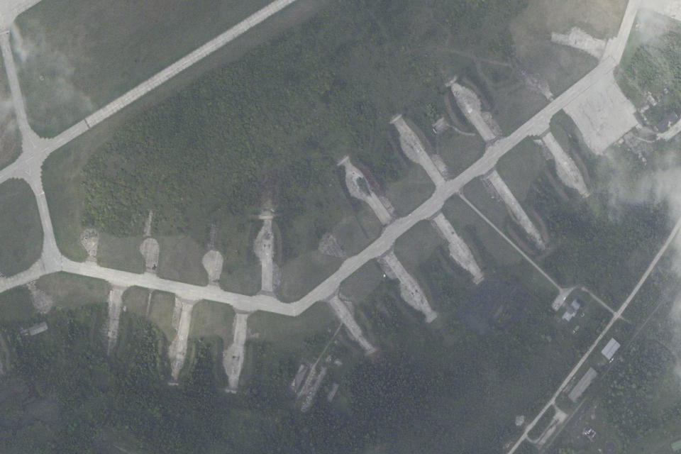 In this satellite photo from Planet Labs PBC, the apron of the Soltsy air base in the Novgorod region of northwestern Russia sits empty Monday, Aug. 21, 2023, after Tupolev Tu-22M bombers once parked on them had left. Ukrainian saboteurs coordinated by Kyiv's military intelligence services carried out a pair of recent drone attacks that hit parked bomber aircraft at air bases deep inside Russia, Ukraine media claimed Tuesday, Aug. 22, 2023. One of those bases was Soltsy, where the bombers had later left, leaving a black spot where one had been earlier parked. (Planet Labs PBC via AP)