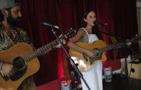 Keiron Marshall and Hannah White play a song on their guitars as they test the sound sytem at the Sound Lounge in London, Thursday, Aug. 6, 2020. More than 400 grassroots music venues in Britain are said to be at imminent risk of closure, although the government is currently pledging 2.25 million pounds in a “culture recovery package”, that wont be enough to reach the grass roots according to organisers. (AP Photo/Alastair Grant)