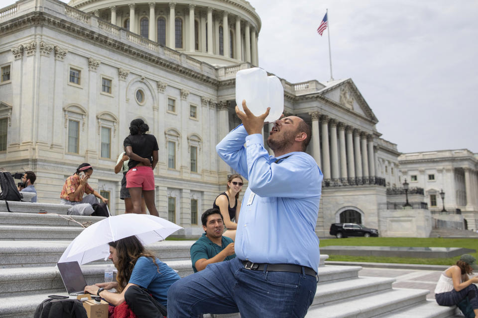 Abbas Alawieh, chief of staff for Rep. Cori Bush, D-Mo., takes a drink of water after sitting on the steps of Capitol Hill in Washington on Tuesday, Aug. 3, 2021. Bush has been camped outside the U.S. Capitol in protest of the eviction moratorium lapse, since the weekend.(AP Photo/Amanda Andrade-Rhoades)