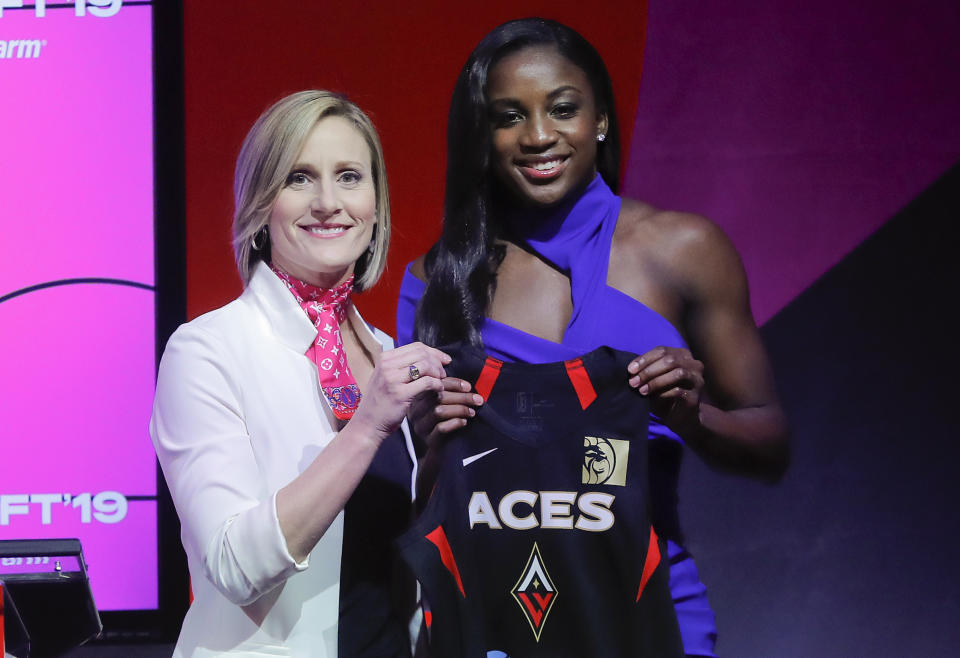 RETRANSMISSION TO CORRECT SPELLING OF NAME - Notre Dame's Jackie Young, right, poses for a photo with WNBA COO Christy Hedgpeth after being selected as the number one pick in the draft by the Las Vegas Aces in the WNBA basketball draft, Wednesday, April 10, 2019, in New York. (AP Photo/Julie Jacobson)