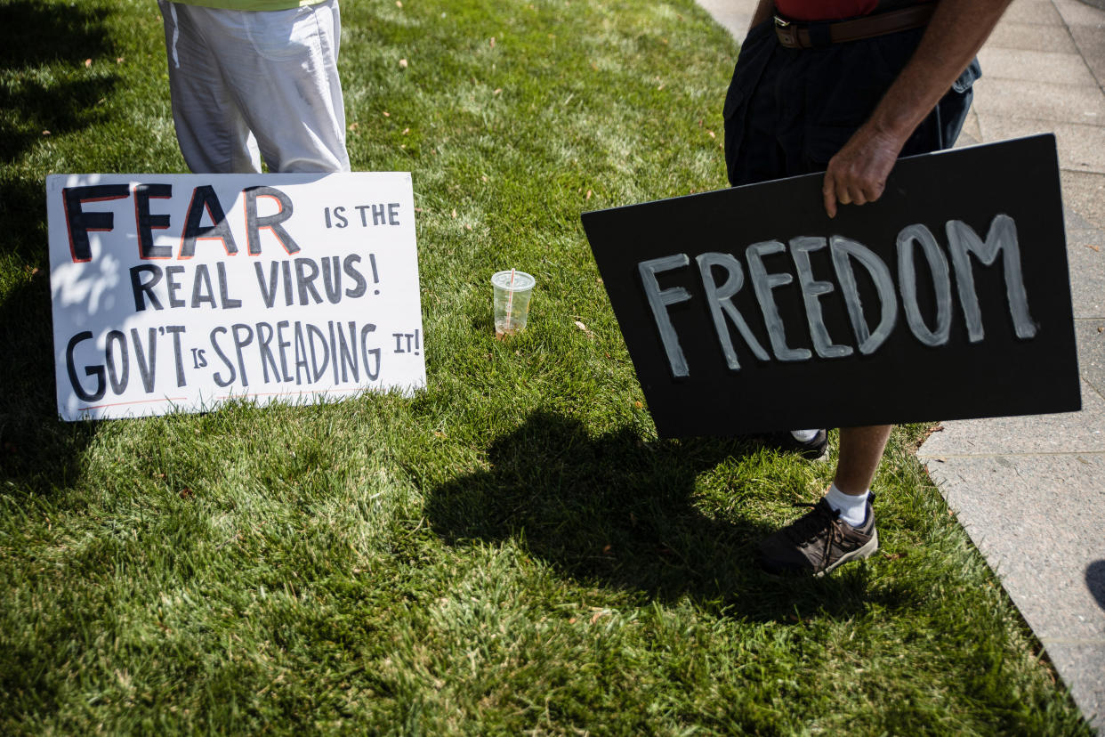 COLUMBUS, UNITED STATES - 2020/07/18: Protesters hold placards during an 'Anti-Mask' rally at Ohio Statehouse. Over 200 people gathered at the Ohio State House to protest against the face mask mandate that multiple counties are under in the state. (Photo by Megan Jelinger/SOPA Images/LightRocket via Getty Images)