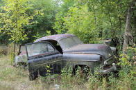 <p>Considering that it’s been sat in a forest for decades, this 1949 Chevrolet is in remarkably good condition. Although the rear fenders are suffering from <strong>severe corrosion</strong>, the rest of the body panels appear to be remarkably sound. Look at the straight edge on the base of the passenger door.</p><p>If you see any parts on this car, or indeed any of the others featured here, be sure to get in touch with Ron’s Auto Salvage before heading to Iowa. The yard is accessed strictly by appointment only.</p>