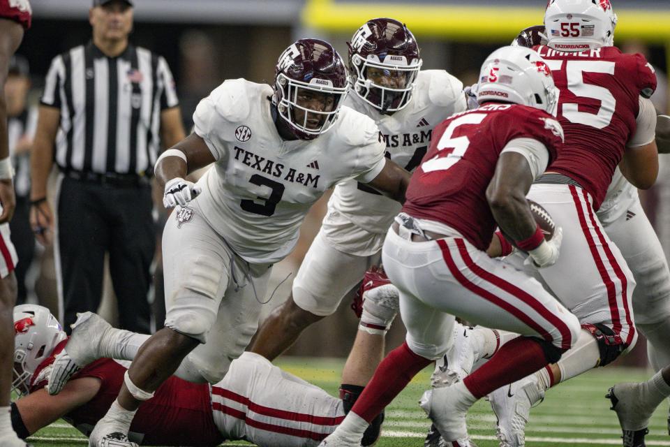 Sep 30, 2023; Arlington, Texas, USA; Texas A&M Aggies defensive lineman McKinnley Jackson (3) and Arkansas Razorbacks running back <a class="link " href="https://sports.yahoo.com/ncaaf/players/322196/" data-i13n="sec:content-canvas;subsec:anchor_text;elm:context_link" data-ylk="slk:Raheim Sanders;sec:content-canvas;subsec:anchor_text;elm:context_link;itc:0">Raheim Sanders</a> (5) in action during the game between the Texas A&M Aggies and the Arkansas Razorbacks at AT&T Stadium. Mandatory Credit: Jerome Miron-USA TODAY Sports