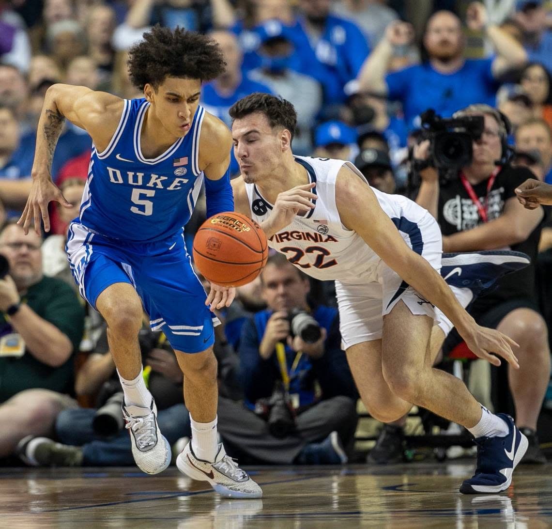 Duke’s Tyrese Proctor (5) makes a steal from Virginia’s Francisco Caffaro (22) during the first half in the championship game of the ACC Tournament on Saturday, March 11, 2023 at the Greensboro Coliseum in Greensboro, N.C