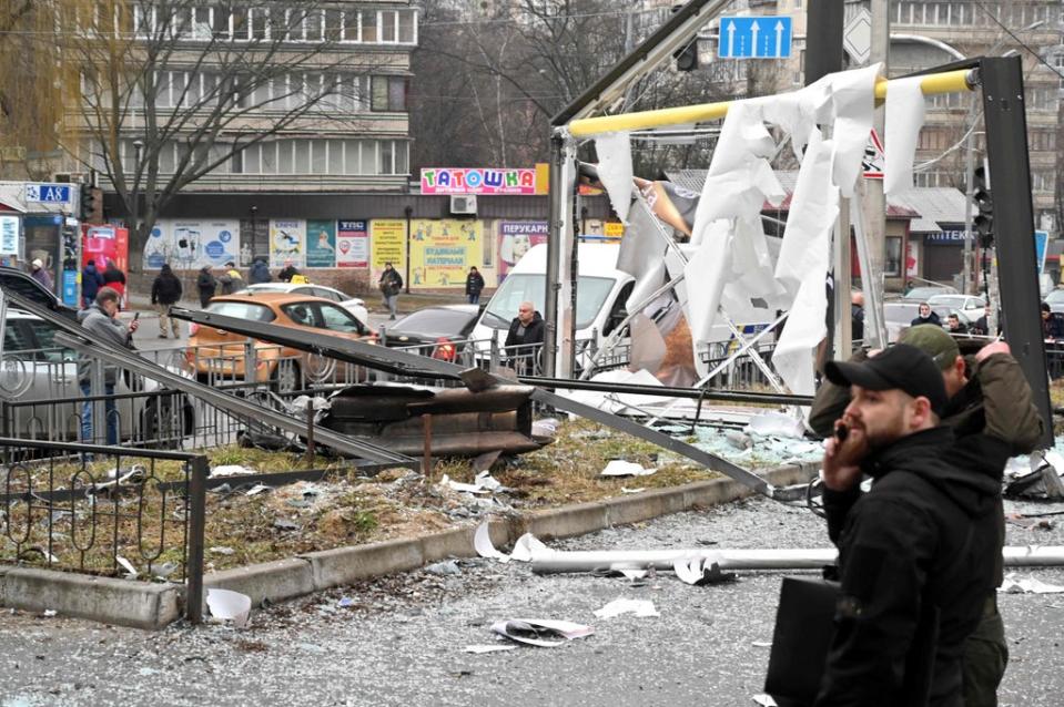 Police and security personnel inspect the remains of a shell landed in Kiev (Sergei Supinsky/AFP via Getty Images)