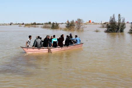 FILE PHOTO: People are seen on a boat after a flooding in Golestan province, Iran, March 24, 2019. Picture taken March 24, 2019. Tasnim News Agency/via REUTERS