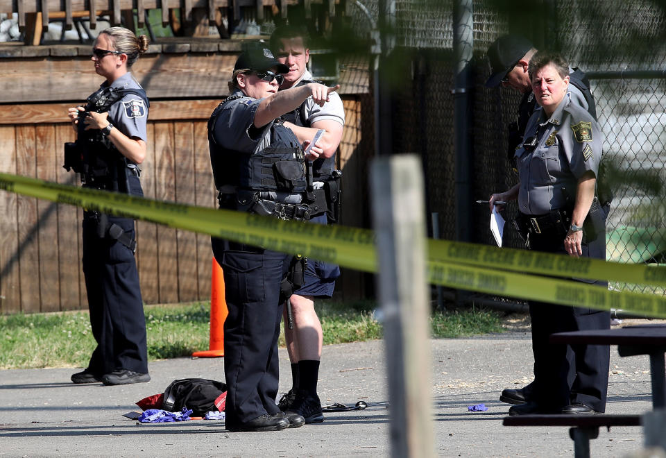 <p>Investigators gather at Eugene Simpson Field, the site where a gunman opened fire June 14, 2017 in Alexandria, Va. (Photo: Win McNamee/Getty Images) </p>