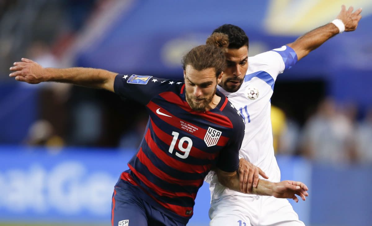 Graham Zusi (19) and the United States had an up-and-down week but ultimately won Group B. (Getty)