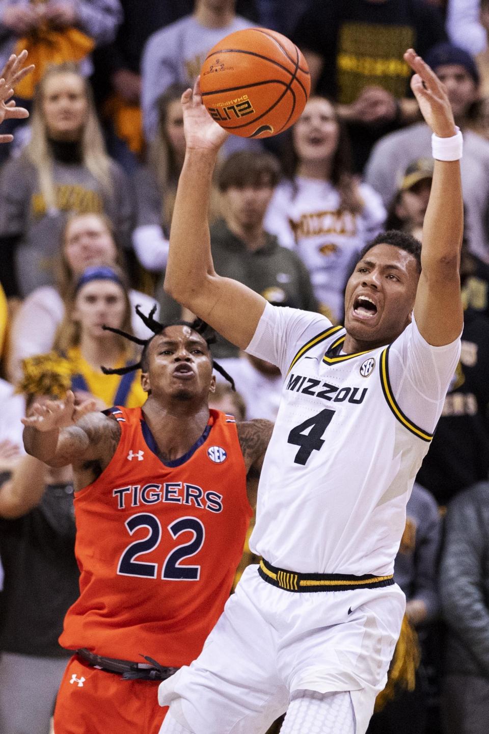 Missouri's Javon Pickett, right, grabs a rebound in front of Auburn's Allen Flanigan, left, during the first half of an NCAA college basketball game Tuesday, Jan. 25, 2022, in Columbia, Mo. (AP Photo/L.G. Patterson)