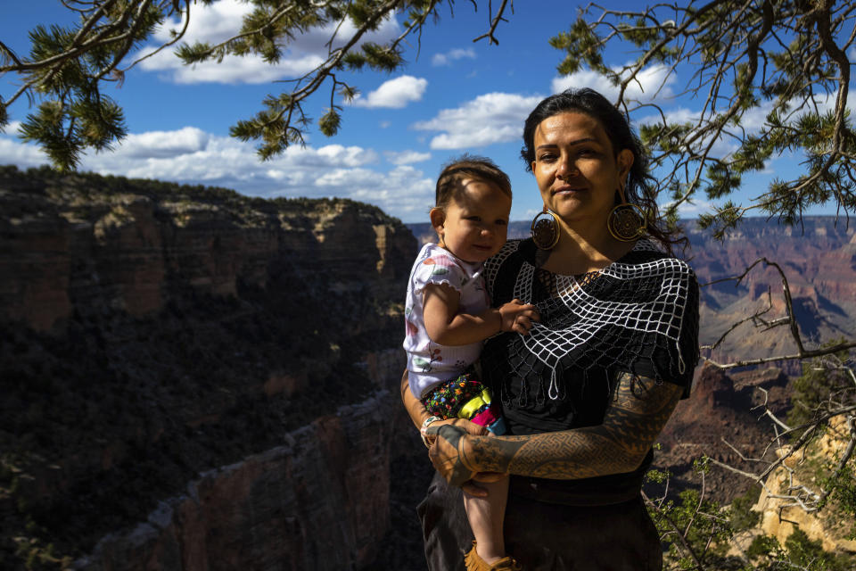 CORRECTS NAME TO OPHELIA WATAHOMIGIE-CORLISS Havasupai tribal member Ophelia Watahomigie-Corliss poses for a photograph with her daughter, Avé Havsuw'a Tilousi Watahomigie-Corliss, at the Grand Canyon's South Rim on Thursday, May 4, 2023. The Havasupai Tribe and the park marked the renaming of a popular campground from Indian Garden to Havasupai Gardens. (AP Photo/Ty O'Neil)