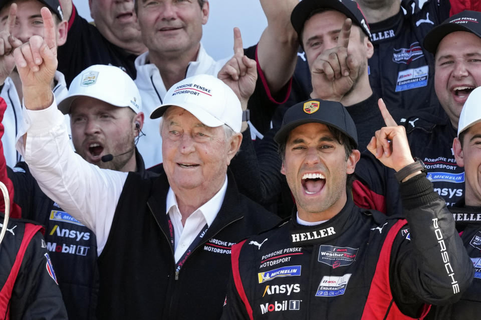 Porsche Penske Motorsport team owner Roger Penske, front left, and driver Felipe Nasr, front right, celebrate in Victory Lane after winning the Rolex 24 auto race at Daytona International Speedway, Sunday, Jan. 28, 2024, in Daytona Beach, Fla. (AP Photo/John Raoux)