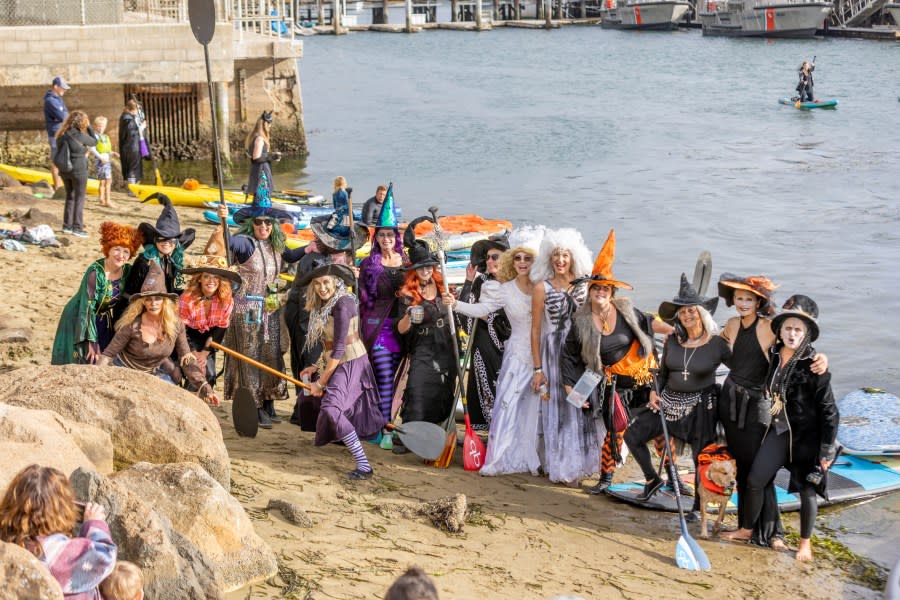 Dozens of people pose on the beach after the annual Morro Bay Witches and Warlocks Paddle.