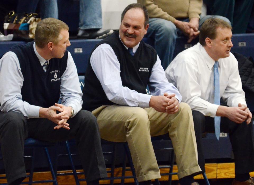 The bond between longtime boys head coach Dennis Starkey (middle) and Sean Pollion (left) kept them as friends and colleagues along the PHS bench.