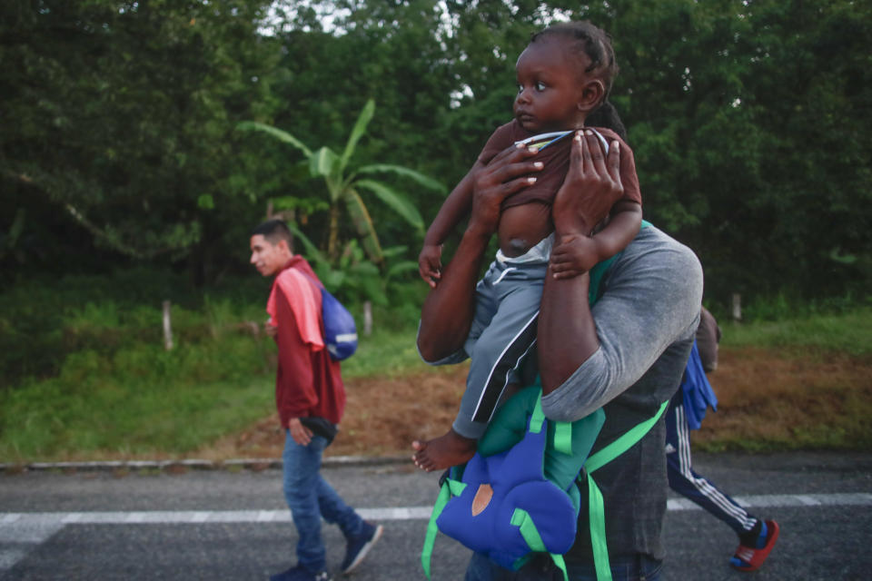 Migrants walk along the highway from Huehuetan to Huixtla in Chiapas state, Mexico, Friday, Nov. 19, 2021, on the second day of their journey from Tapachula, toward the northern states of Mexico and the U.S. border. (AP Photo)