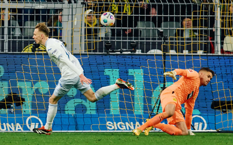 Hoffenheim's Maximilian Beier (L) celebrates scoring his side's third goal during the German Bundesliga soccer match between Borussia Dortmund and TSG 1899 Hoffenheim at Signal Iduna Park. Bernd Thissen/dpa