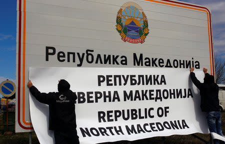 Workers set up a sign with Macedonia's new name at the border between Macedonia and Greece, near Gevgelija, Macedonia February 13, 2019. REUTERS/Ognen Teofilovski