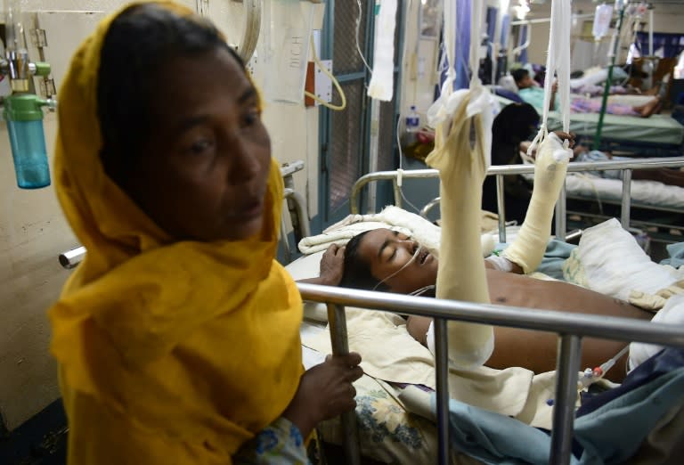 Rohingya Muslim refugee Rashida Begum (L) stands next to her son Azizul Hoque, 15, who was wounded by a landmine while crossing from Myanmar to Bangladesh