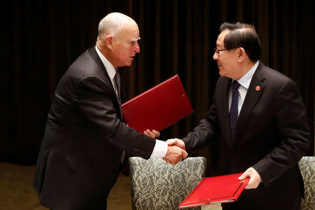 California Governor Jerry Brown and Chinese Minister of Science and Technology Wan Gang attend a signing ceremony at the International Forum on Electric Vehicle Pilot Cities and Industrial Development in Beijing, China June 6, 2017. REUTERS/Thomas Peter