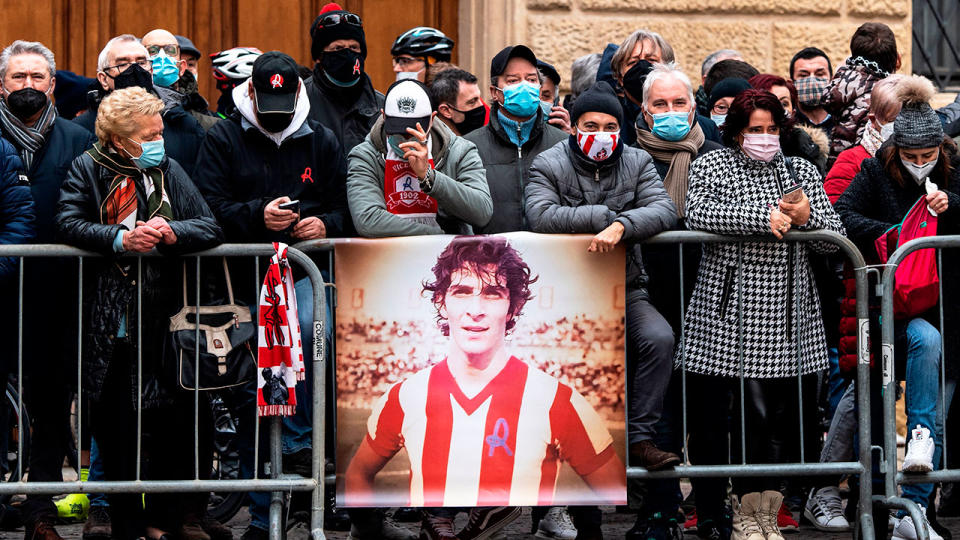 Supporters can be seen here gathered outside the funeral service for Italian football great Paolo Rossi.