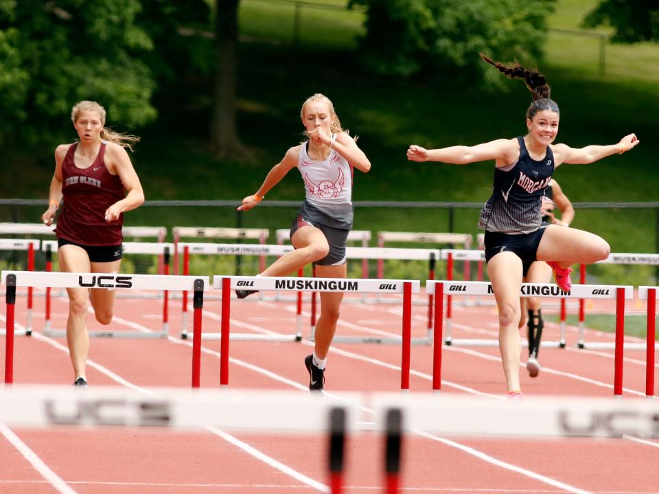 John Glenn's Kara Fields, left, Sheridan's Claire Shriner and Morgan's Odessa Smith run the 300 hurdles at the Division II regional track and field meet on Saturday at McConagha Stadium in New Concord. All three advanced to compete in this weekend's state meet.