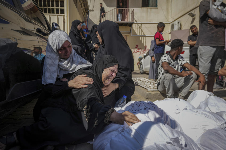 Palestinians mourn their relatives killed in the Israeli bombardment of the Gaza Strip in a hospital in Deir al Balah on Tuesday, June 18, 2024. (AP Photo/Abdel Kareem Hana)