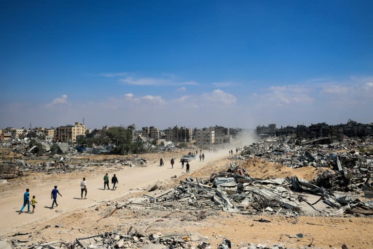 Des Palestiniens de retour à Khan Younès, grande ville du sud de Gaza, après le retrait des troupes israéliennes, le 7 avril 2024 (-)