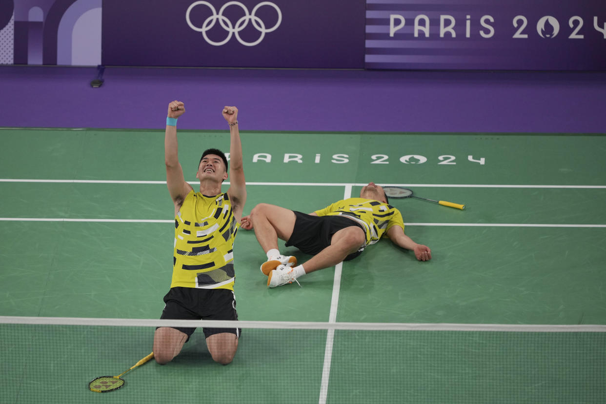 Taiwan's Lee Yang, right, and Wang Chi-lin celebrate after defeating China's Liang Weikeng and Wang Chang during their men's doubles gold medal match at the Summer Olympics on Sunday.