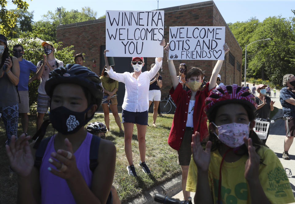 FILE - Supporters of Otis Campbell raise signs at a rally after a bicycle ride to Tower Road Beach on Sept. 5, 2020, in Winnetka, Ill. A white woman charged with a hate crime following a confrontation where she told a group of Black men in 2020 that they couldn't be at a suburban Chicago beach has been sentenced to probation after pleading guilty to a lesser charge. The felony hate crime charge Irene Donoshaytis had faced in Cook County was amended Wednesday, Oct. 19, 2022, to a misdemeanor battery under a plea agreement. (John J. Kim/Chicago Tribune via AP, File)